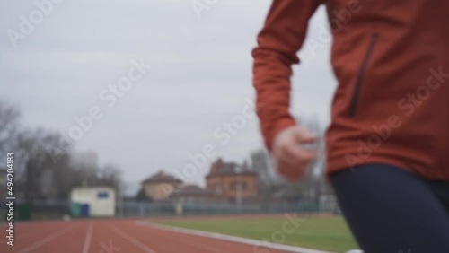 Portrait of woman in sportswear doing jogging at the stadium