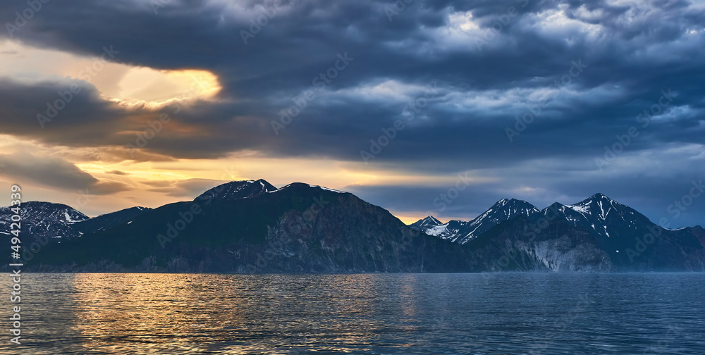 Sea sunset on the background of volcanoes and mountains. Kamchatka, Russia. Sea cruises and travel	
