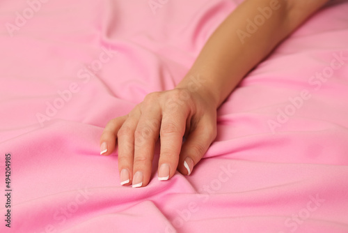 Woman touching delicate pink fabric  closeup view