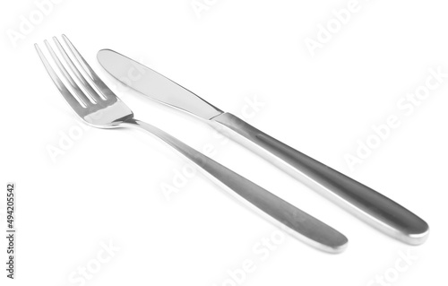Shiny fork and knife on white background