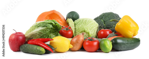 Pile of fresh ripe vegetables and fruits on white background