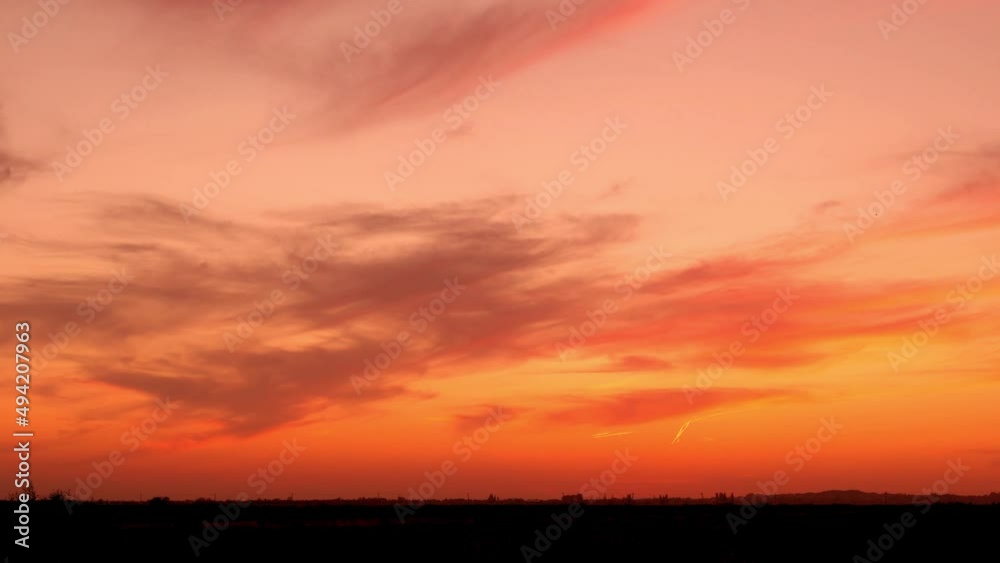 Timelapse Beautiful Orange Red Sky with Light Cirrus Clouds at Sunset in the Field, Horizon. Colorful Summer Skyscraper in the Field at Sunset Evening, Time Lapse. Timelapse Beautiful Orange Red Sky with Light Cirrus Clouds at Sunset in the Field, Horizon. Colorful Summer Skyscraper in the Field at Sunset Evening, Time Lapse.