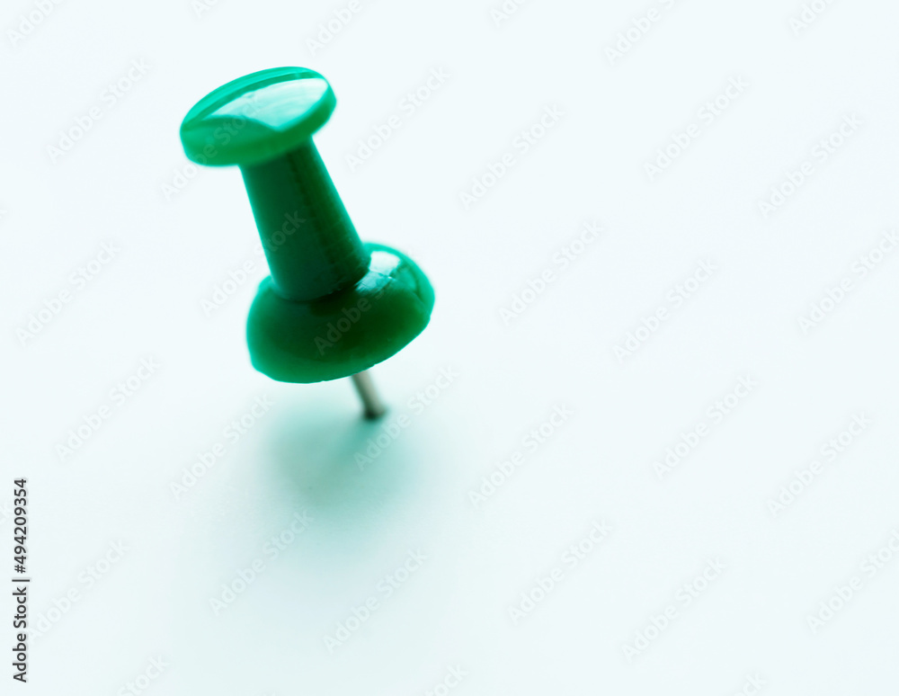 Single pushpin on white background Single pushpin on white background