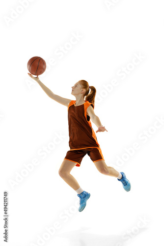 Full-length portrait of young sportive girl, professional basketball player in motion, training isolated over white studio background © master1305