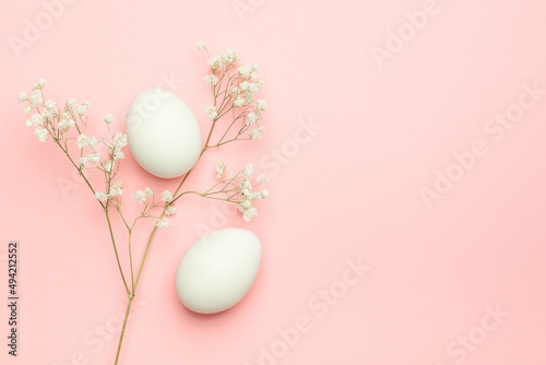 Eggs with gypsophila on a pink background. Happy Easter concept. Minimal concept.