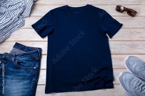 Unisex navy blue T-shirt mockup with trainers and jeans