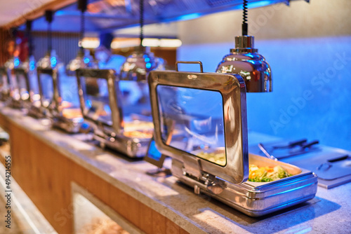 All inclusive buffet food in heating trays in hotel restaurant photo