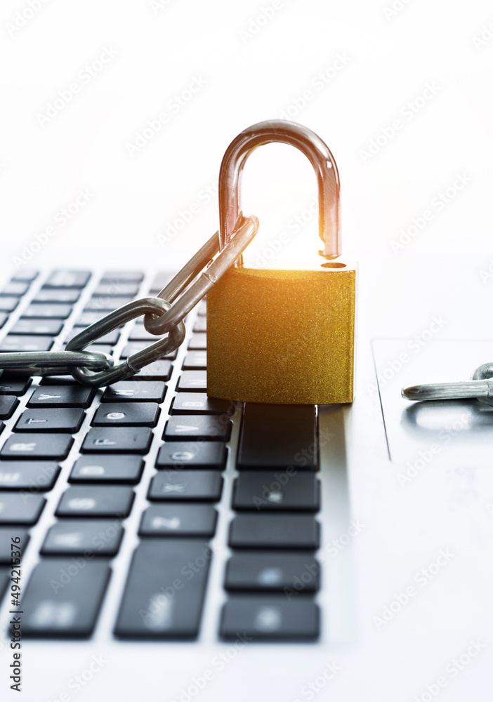 Close up of laptop with chain and padlock Close up of laptop with chain and padlock
