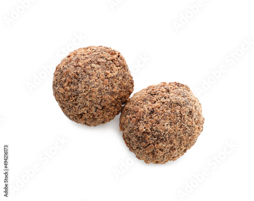 Delicious chocolate truffles on white background, top view