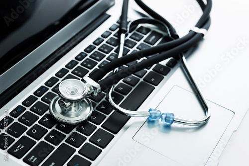 Stethoscope on the keyboard of laptop computer