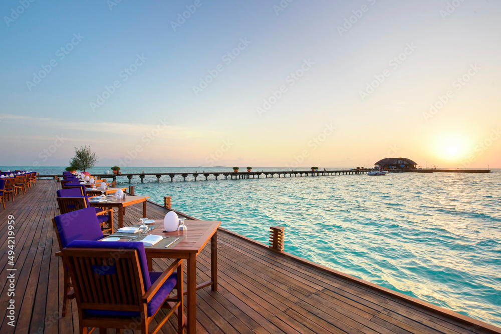 Outdoor restaurant at the beach Romantic Sunset view in Maldives Island