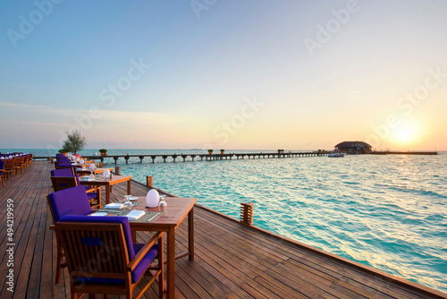 Fototapeta Naklejka Na Ścianę i Meble -  Outdoor restaurant at the beach Romantic Sunset view in Maldives Island