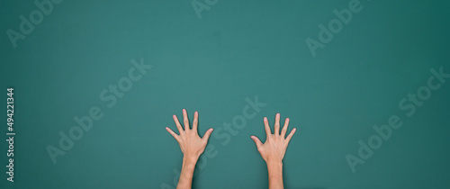 Raised hands in front of chalkboard