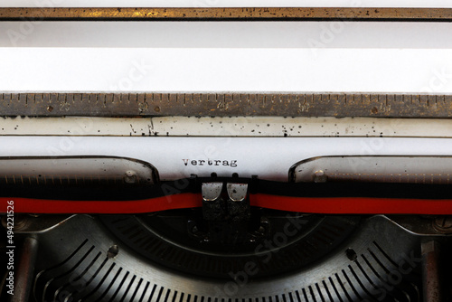 The German word Vertrag written on an old mechanical typewriter German Text: Contract