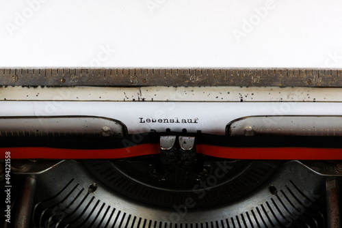 The German word Lebenslaufwritten on an old mechanical typewriter German Text: Curriculum vitae