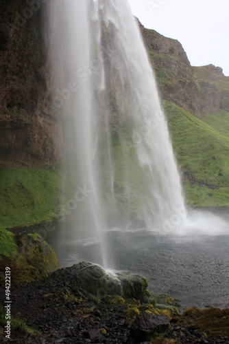 World famous Icelandic Seljalandsfoss waterfall with its characteristic veil (vertical), Seljalandsfoss, Iceland