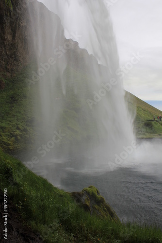 World famous Icelandic Seljalandsfoss waterfall with its characteristic veil (vertical), Seljalandsfoss, Iceland
