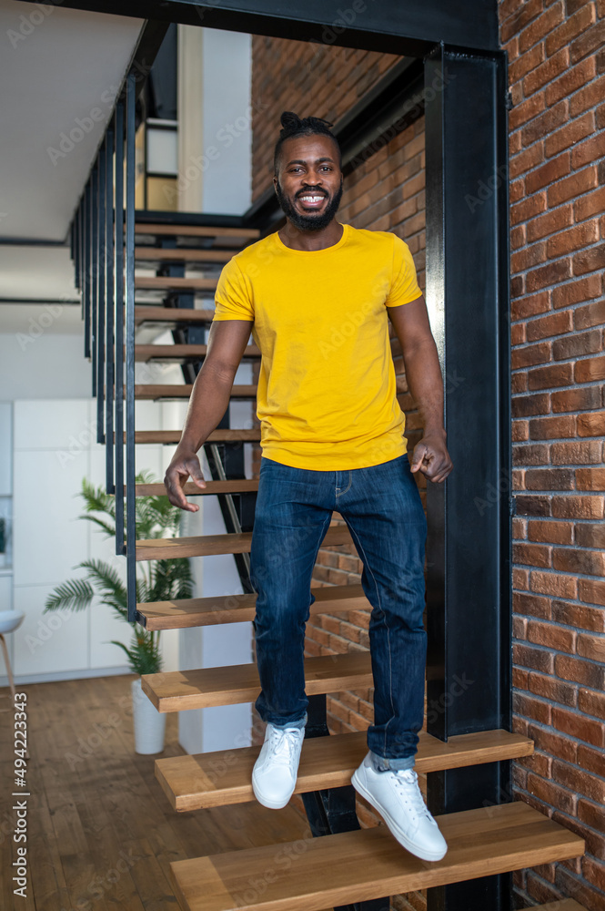 Fototapeta premium Man descending stairs in apartment