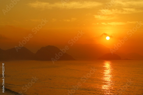 Stunning sunrise over the Atlantic ocean view from Copacabana beach, Rio de Janeiro, Brazil © jobi_pro
