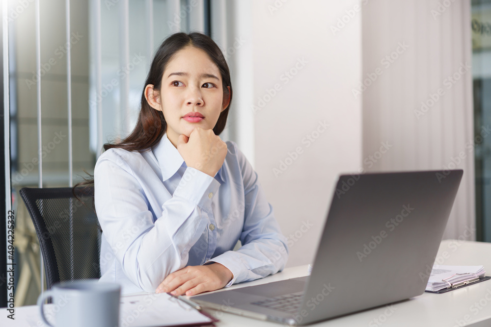 Business concept, Businesswoman sit to thoughtful about new project while looking out the window Business concept, Businesswoman sit to thoughtful about new project while looking out the window
