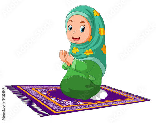 The muslim women is praying on the rug