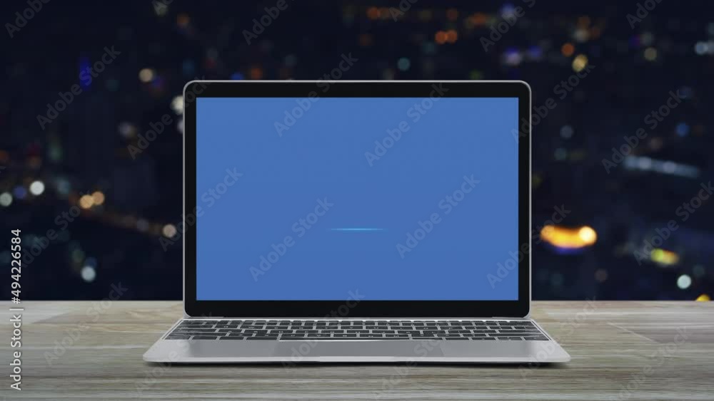 Microphone flat icon on modern laptop computer screen on wooden table over blur colorful night light office city tower and skyscraper, Business communication online concept