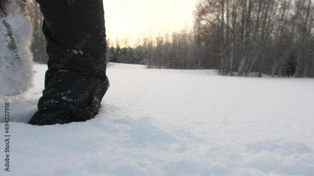 Man walks through deep snow, low follow shot Man walks through deep snow, low follow shot
