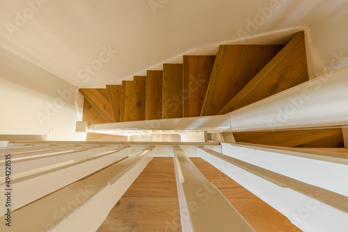 Typical british wooden staircase and white railings