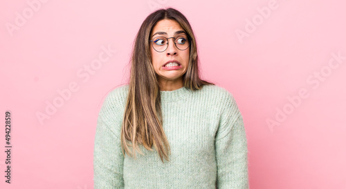pretty hispanic woman looking worried, stressed, anxious and scared, panicking and clenching teeth