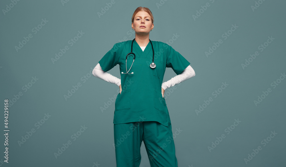 Female doctor wearing green scrubs in a studio Stock Photo | Adobe Stock