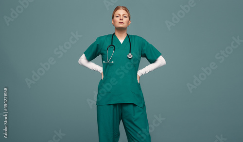 Female doctor wearing green scrubs in a studio photo