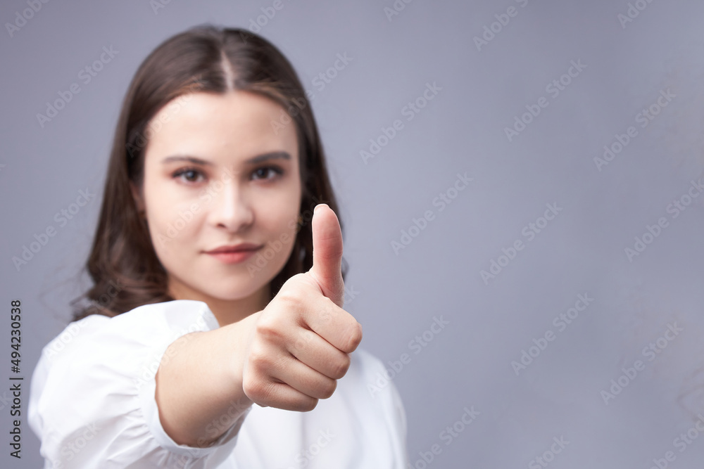 young brunette woman hand gesture thumbs up young brunette woman hand gesture thumbs up