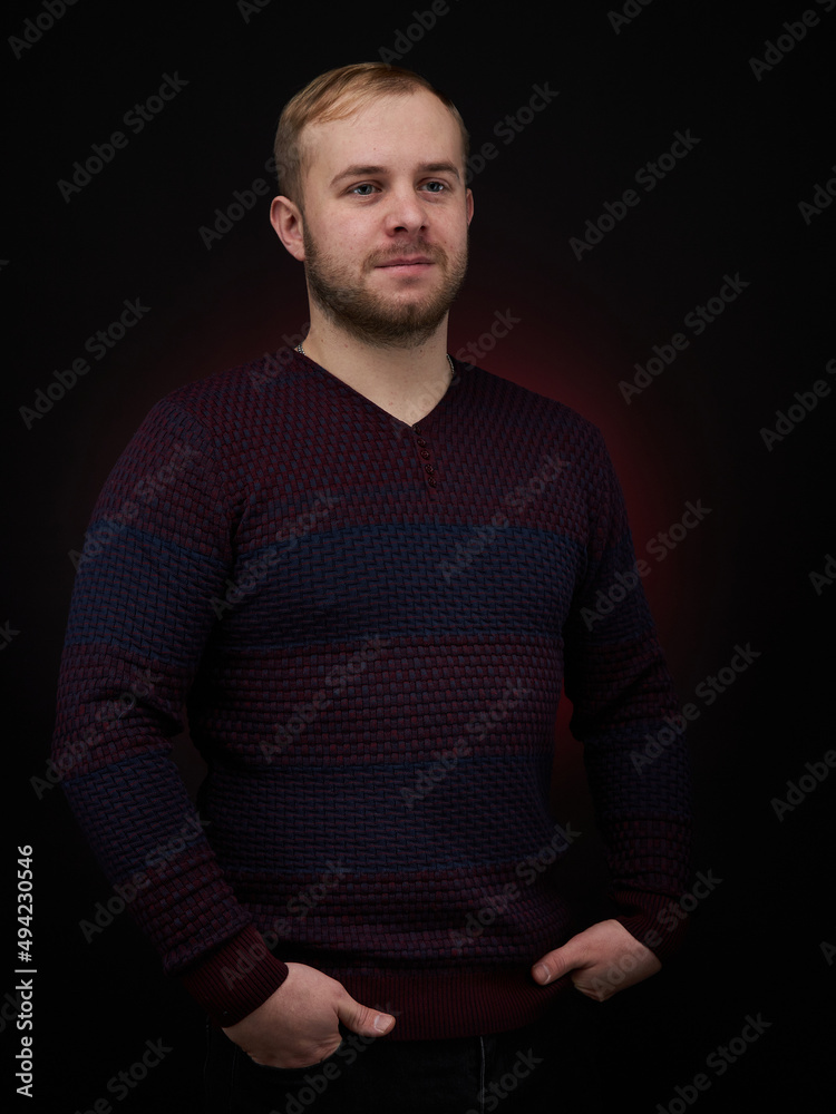 vertical portrait blond man on a dark background, in a jacket vertical portrait blond man on a dark background, in a jacket