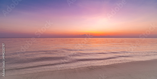 Closeup sea sand beach. Panoramic beach landscape. Inspire tropical beach seascape horizon. Purple gold sunset sky peaceful tranquil relaxing sunlight summer mood. Vacation coast travel holiday banner