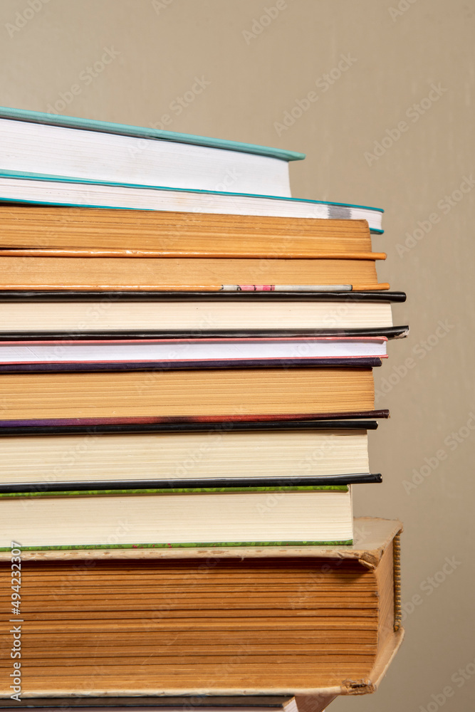 Fototapeta premium Close-up of background stack of old used books. Pile of vintage old books. Back to school