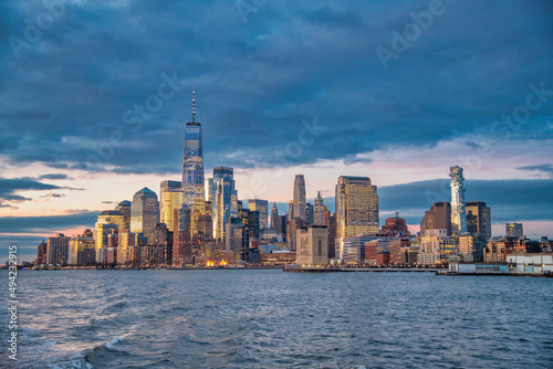 Sunset skyline of Downtown Manhattan as seen from a ferry boat tour around New York City. © jovannig