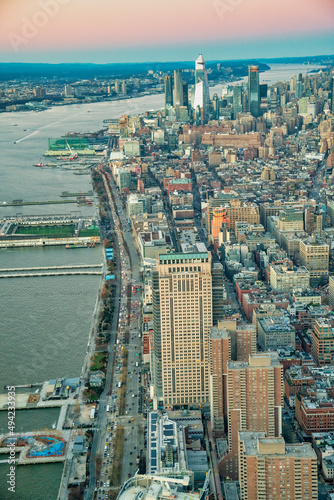 Aerial view of Manhattan West Side skyline along Hudson River at sunset .