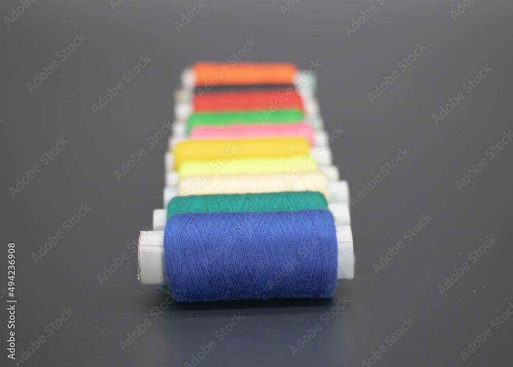 different color yarn on spool, yarn on tube, cotton, wool, linen thread, isolate on black background different color yarn on spool, yarn on tube, cotton, wool, linen thread, isolate on black background