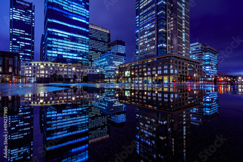 Photography Night city view of business buildings around the Marunouchi side of Tokyo Station after rain