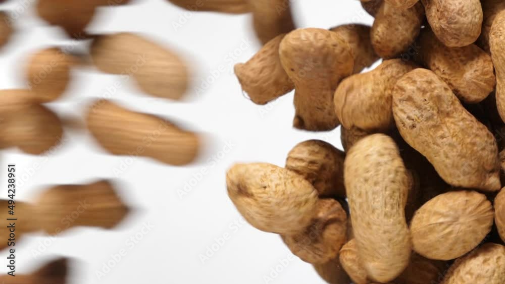 peanuts fall in slow motion and cover the whole screen, vertical video