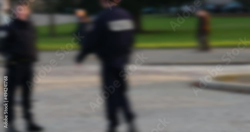 French police car surveilling large crowd of protesters manifestation political rally in city center