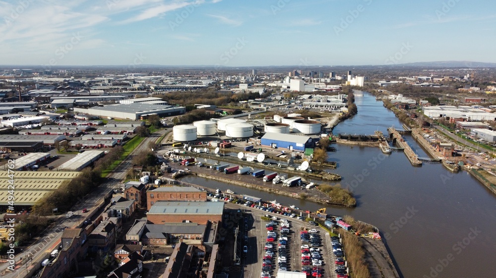 Drone image of Salford Quays with modern buildings and landmarks and views towards Manchester. 