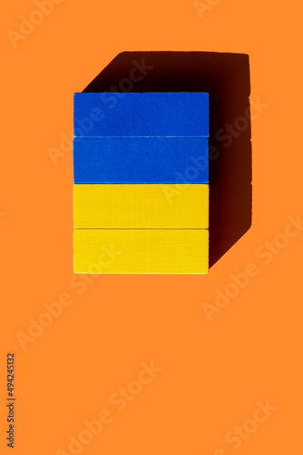 bright blue and yellow blocks on orange background, top view, ukrainian concept. photo