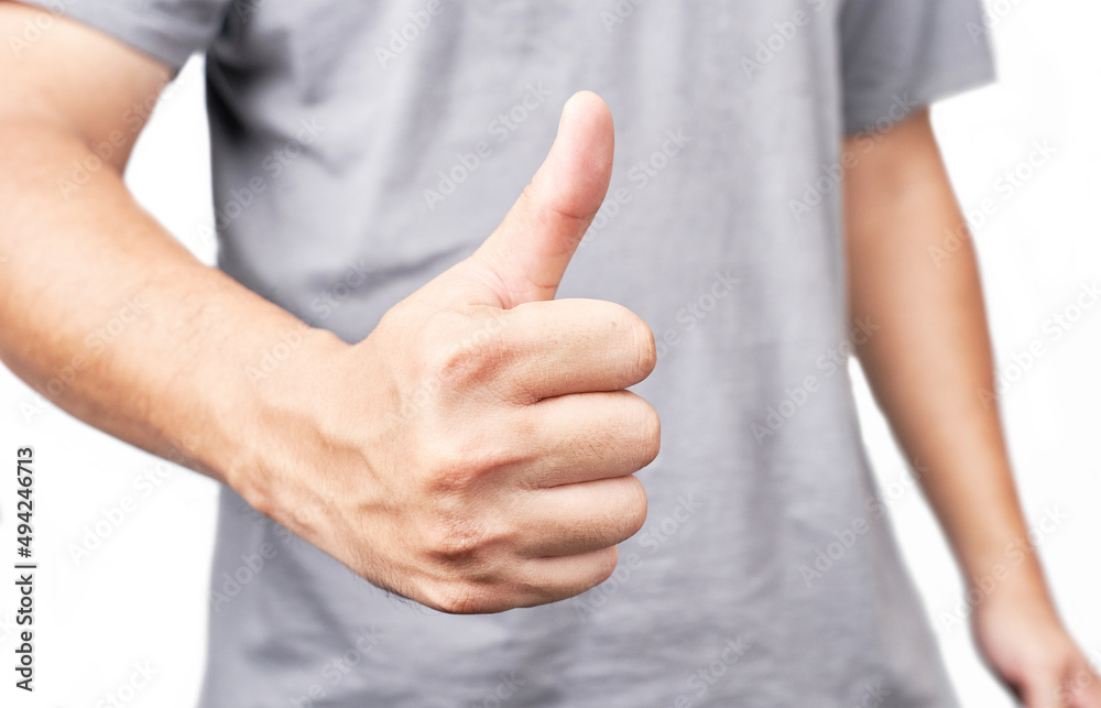 Asian man showing thumbs up closeup shot isolated on white background Asian man showing thumbs up closeup shot isolated on white background