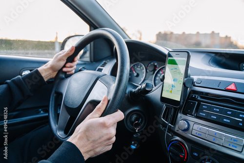 Gps navigation map system. Global positioning system on smartphone screen in auto car on travel road. GPS device satellite system technology. © Maksym