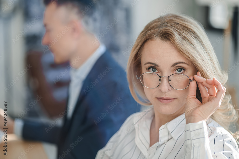 Blonde serious business lady working in the office Blonde serious business lady working in the office