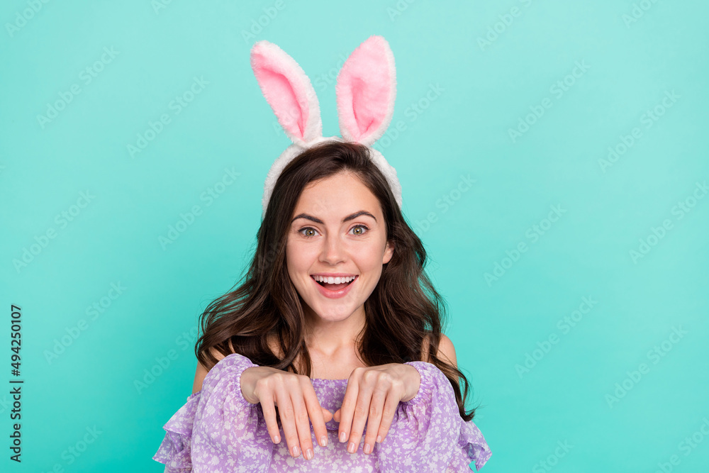 Photo of satisfied cheerful person arms make bunny paws toothy smile isolated on teal color background