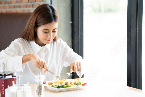 Asian woman having lunch in a restaurant