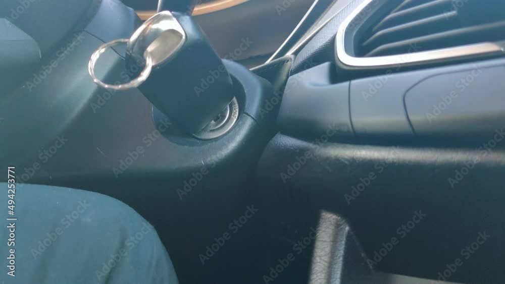 Putting the car key into keyhole and start car engine. Start the car with key. Putting the car key into keyhole and start car engine. Start the car with key.