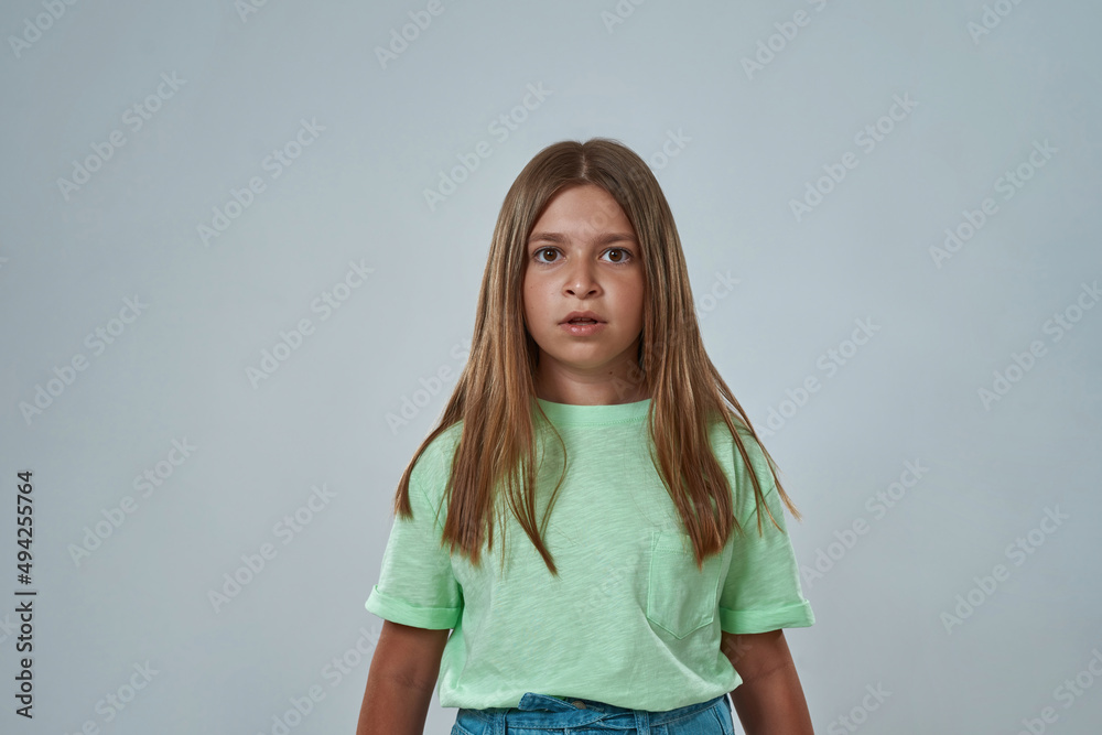 Front view of focused little girl look at camera Front view of focused little girl look at camera